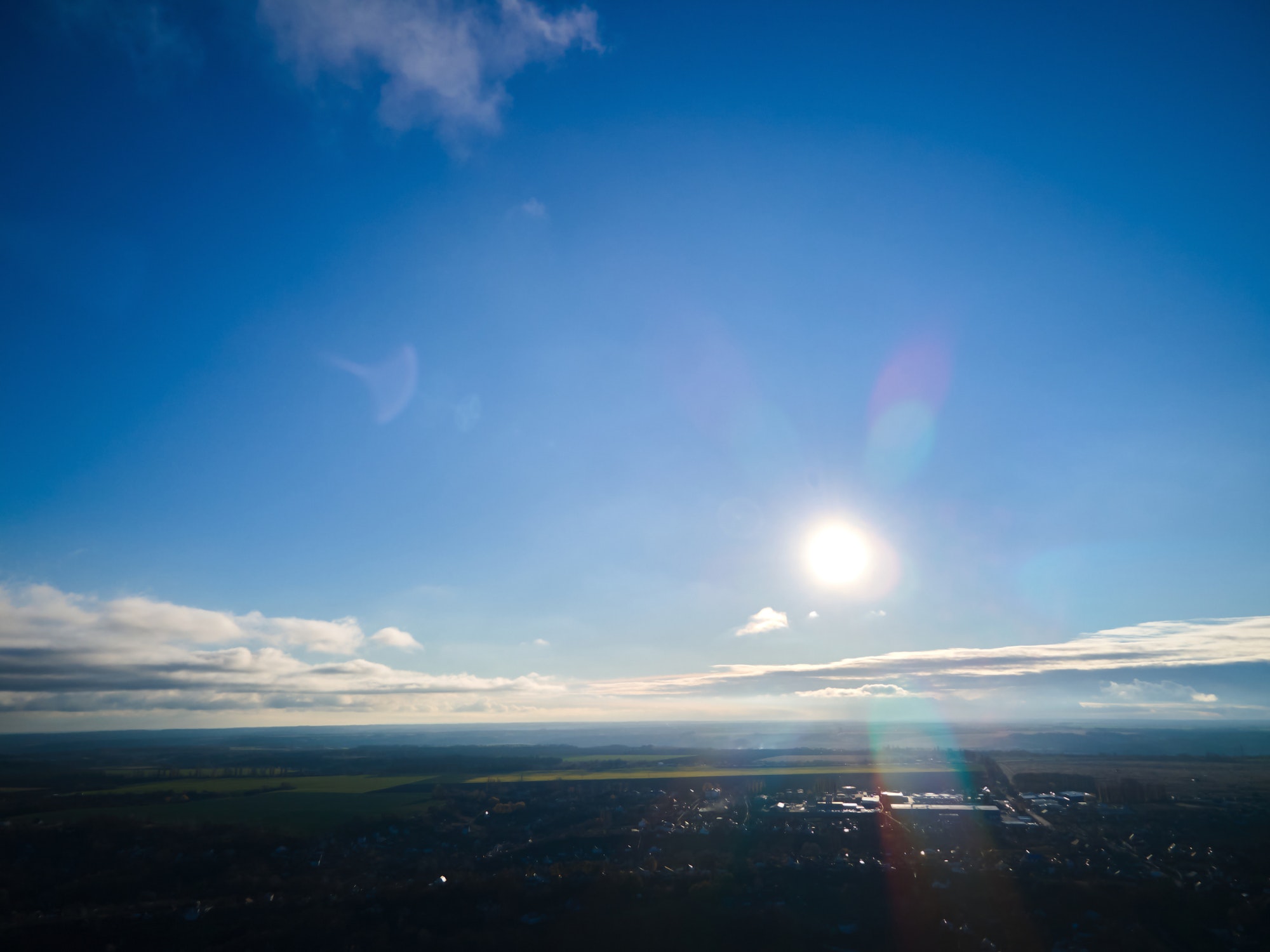 Bright sun light, sunbeams, flares shining through sunrise clouds, cloudscape